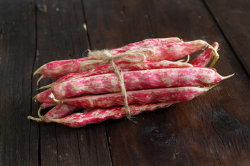 Pinto beans with pods on a wooden table