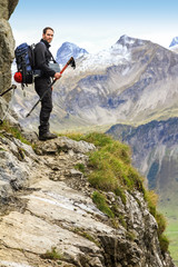 Man walks on dangerous trail in alpine mountains. Alps, Allgau.