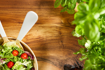 Fresh healthy salad on wooden table. View from above with copy space