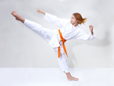 With an orange belt the girl beats kick leg