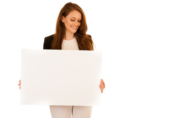 attractive business woman holding white banner with copy spave for additional text or graphic...
