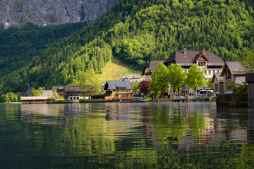 Fototapeta na wymiar Scenic picture-postcard view of traditional old wooden houses in famous Hallstatt mountain village at Hallstattersee lake in the Austrian Alps in summer, region of Salzkammergut, Austria