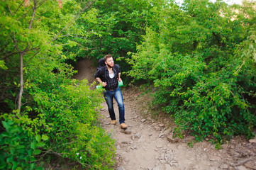 Obraz premium Traveler man walking with backpack in rocky mountains. Travel concept.