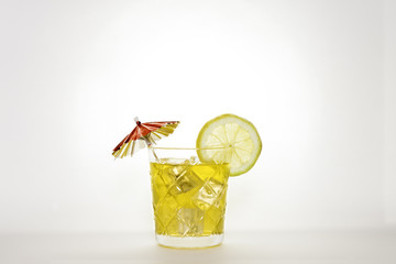 Orange soda on white background with lemon