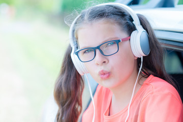 Cute girl listening to music with headphones outdoor