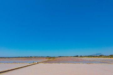 Salt mills are seen in suburbs of Marsala, Sicily, Italy. Copy space