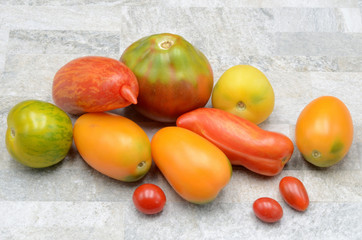 Many Tomatos on a stone background photo