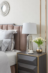 classic bedroom style with set of pillows and lamp on table side