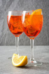 Aperol spritz cocktail in glass on gray stone
