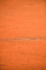 Shoe footprints on a tennis clay court