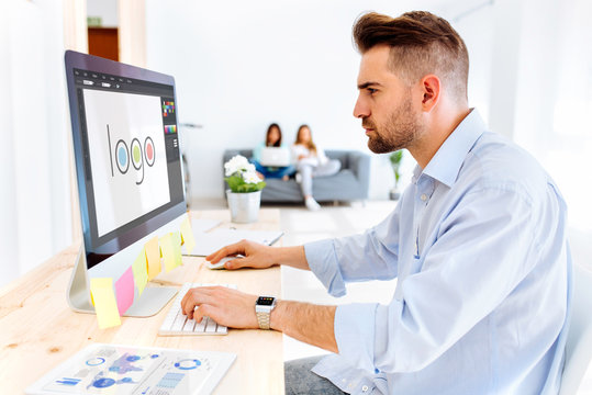 Hipster man designing a logo