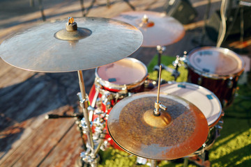 Fototapeta na wymiar Music in the park, drums on background wooden floors