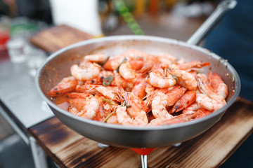 Fried king prawns on iron pan.