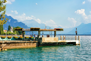 Fototapeta na wymiar People at landing stage on Geneva Lake in Vevey Riviera