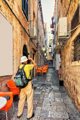 Man taking photos of tight street of Dubrovnik