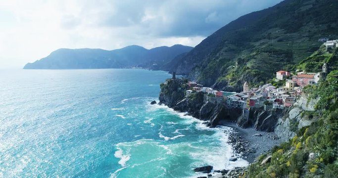 aerial view of travel landmark destination Vernazza,small mediterranean sea town,Cinque terre National Park, Liguria, Italy. Afternoon sunny and cloud. 4k slow motion 60 fps drone forward video