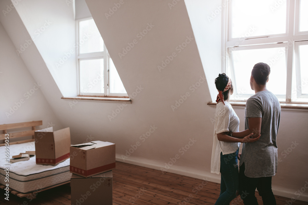 Wall mural young couple in new home