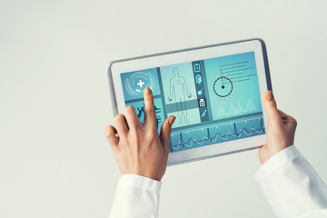 Close of female doctor hands working with tablet pc computer
