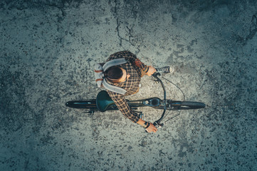 Young Guy Cyclist Riding On Bike Down The Street, Top View. Daily Lifestyle Urban Resting Concept