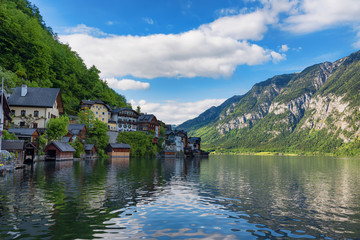 Fototapeta na wymiar Scenic picture-postcard view of traditional old wooden houses in famous Hallstatt mountain village at Hallstattersee lake in the Austrian Alps in summer, region of Salzkammergut, Austria