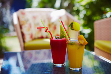 cocktails served on table of cozy patio with armchairs