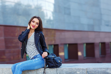 Fototapeta premium Young woman posing in black jacket. Fashion makeup