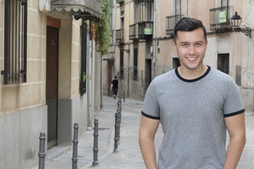 Young Hispanic male smiling outside