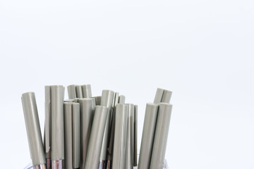 Fototapeta premium A lot of ballpoint pens on a white background.
