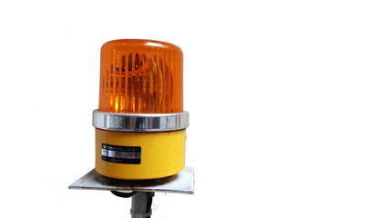 Orange rotating beacon on white reflective background.