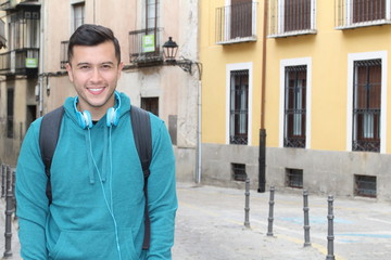 Handsome joyful mixed race person heading to school with copy space for text 