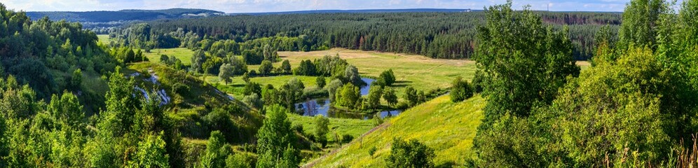 Fototapeta na wymiar Summertime landscape banner, panorama - river valley of the Siverskyi (Seversky) Donets, the winding river over the meadows between hills and forests, border region of Ukraine near to Russia