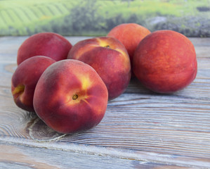 Peaches are on a table. Fruit are fresh, juicy, mature, tropical.