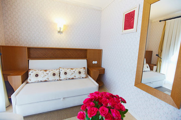 Cozy small hotel bedroom decorated for guests