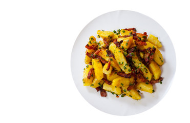 fried potatoes with bacon in a plate. top view. isolated on white