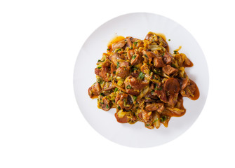 Stewed meat with mushrooms and vegetables in a plate. top view. isolated on white