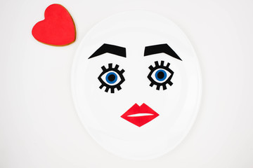paper face with makeup on plate