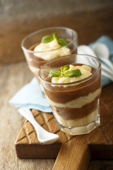 Homemade pudding with vanilla custard, banana and cocoa