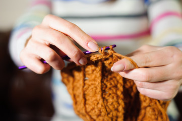 Close up of hands knitting. Process of knitting.