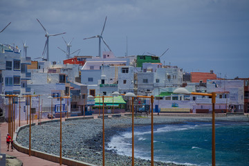 City on the ocean with windmills
