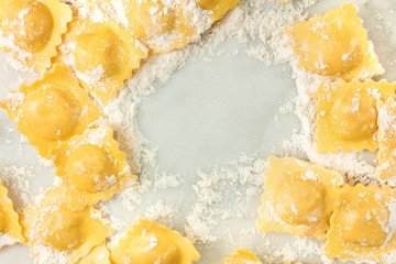 Overhead photo of ravioli with flour and copy space