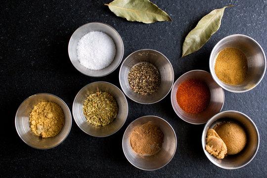Assorted Indian spices in metal cups