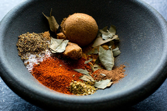 Indian spices in black bowl