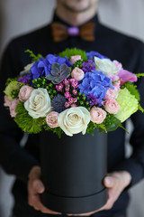 elegant man deliveries flowers in the box