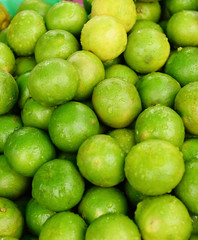 limes stacked up for sale on a market