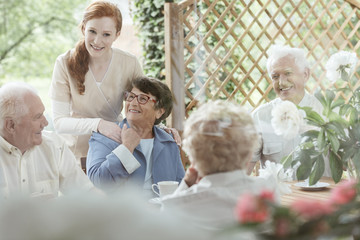 Volunteer supports an older woman