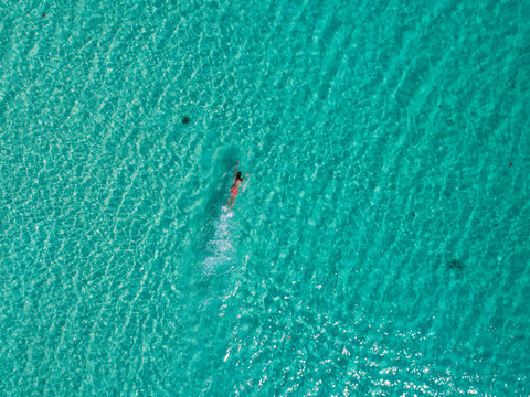 Man swimming in the amazingly blue ocean of Cambodia
