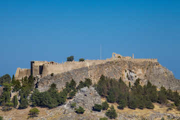 Acropolis on a hill in the city of Lindos. Fragment of residential buildings at the foot of the...
