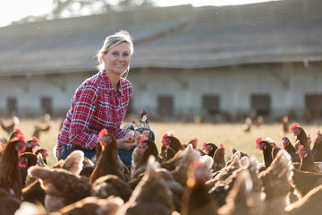 female farmer in farm with chicken