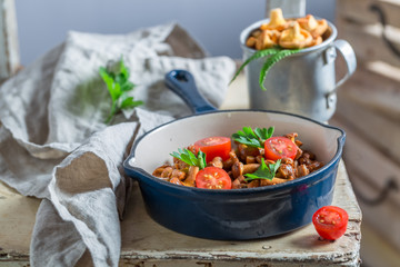 Delicious fried mushrooms with cherry tomatoes and parsley