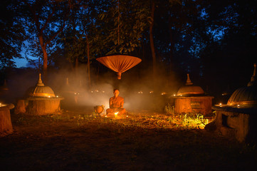 Buddhist monks sitting samati on temple at night,Thailand